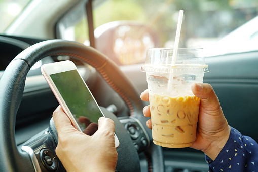 Driving while using a cellphone and drinking iced coffee